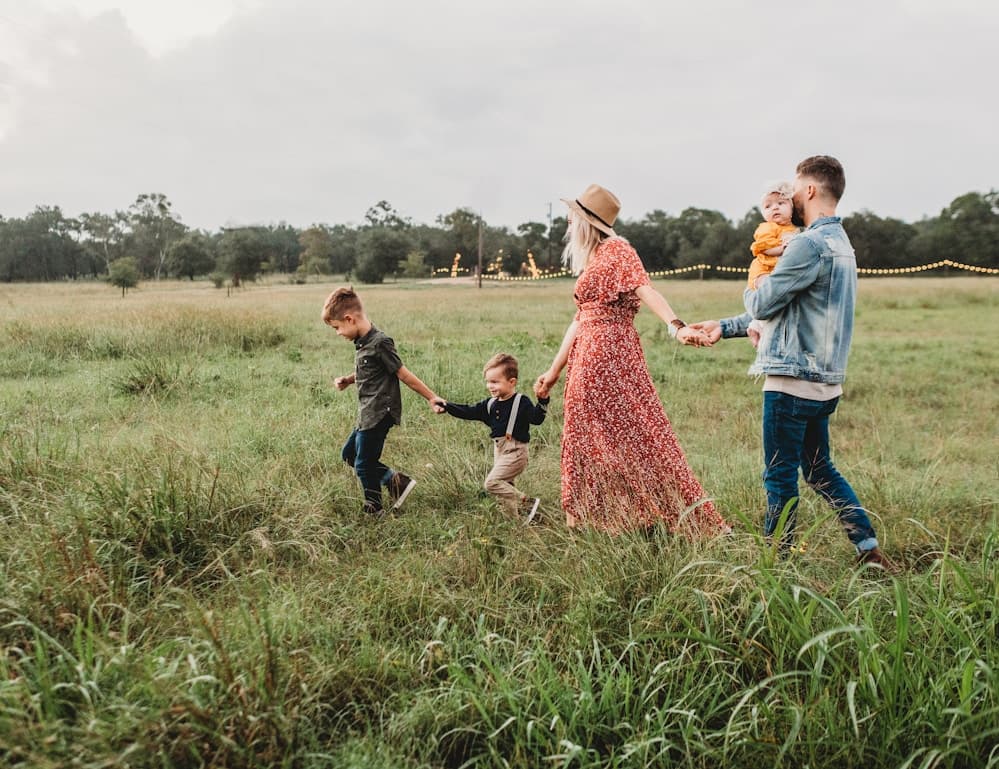 Family walking together outdoors during golden hour