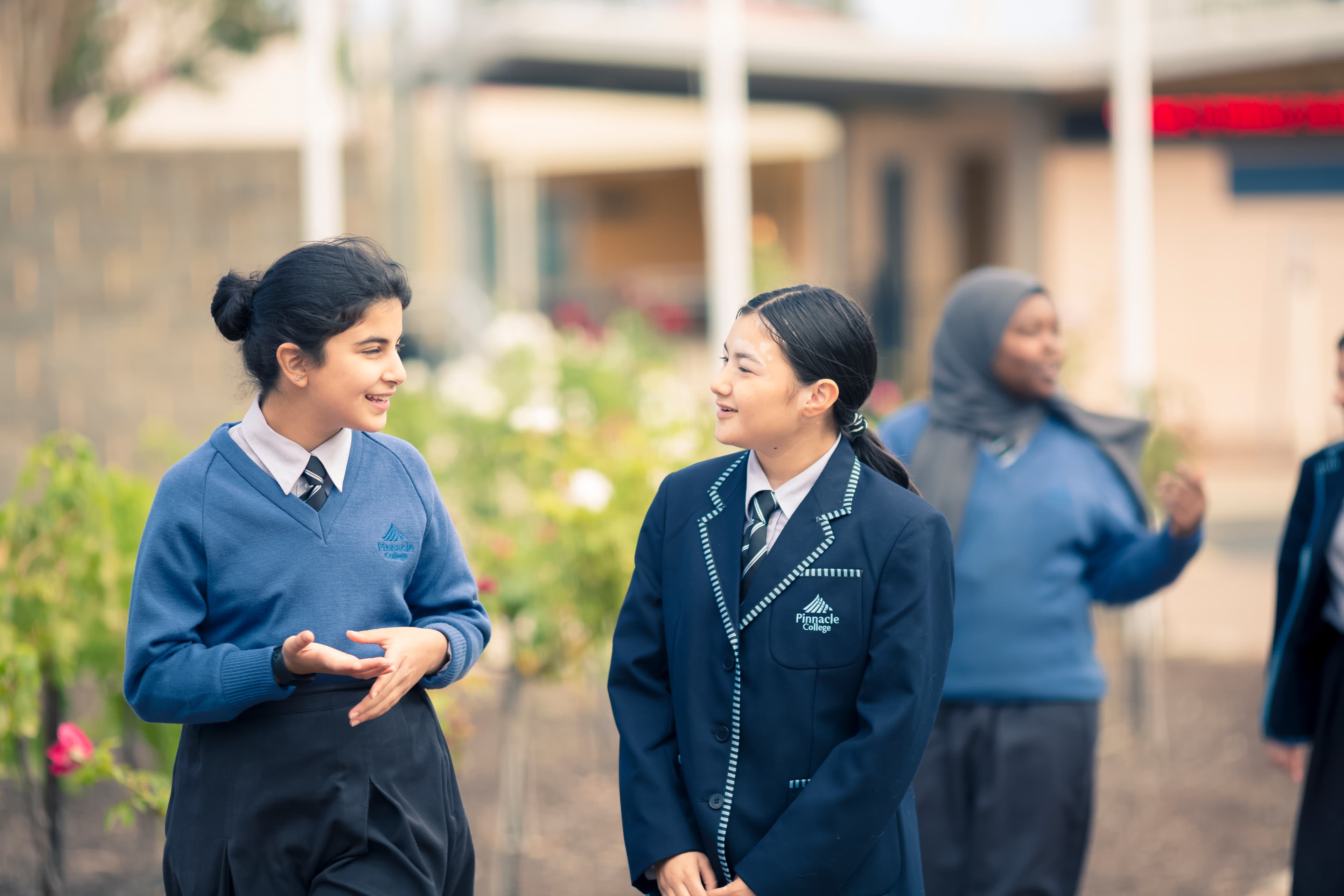 School campus exterior with students walking between buildings